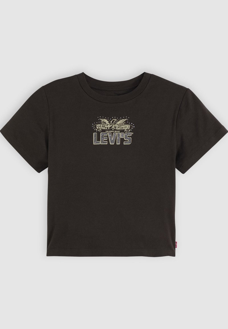 T-shirt en coton noir à manches courtes et col rond. Présente un logo graphique doré et argenté sur le devant avec des éléments décoratifs.