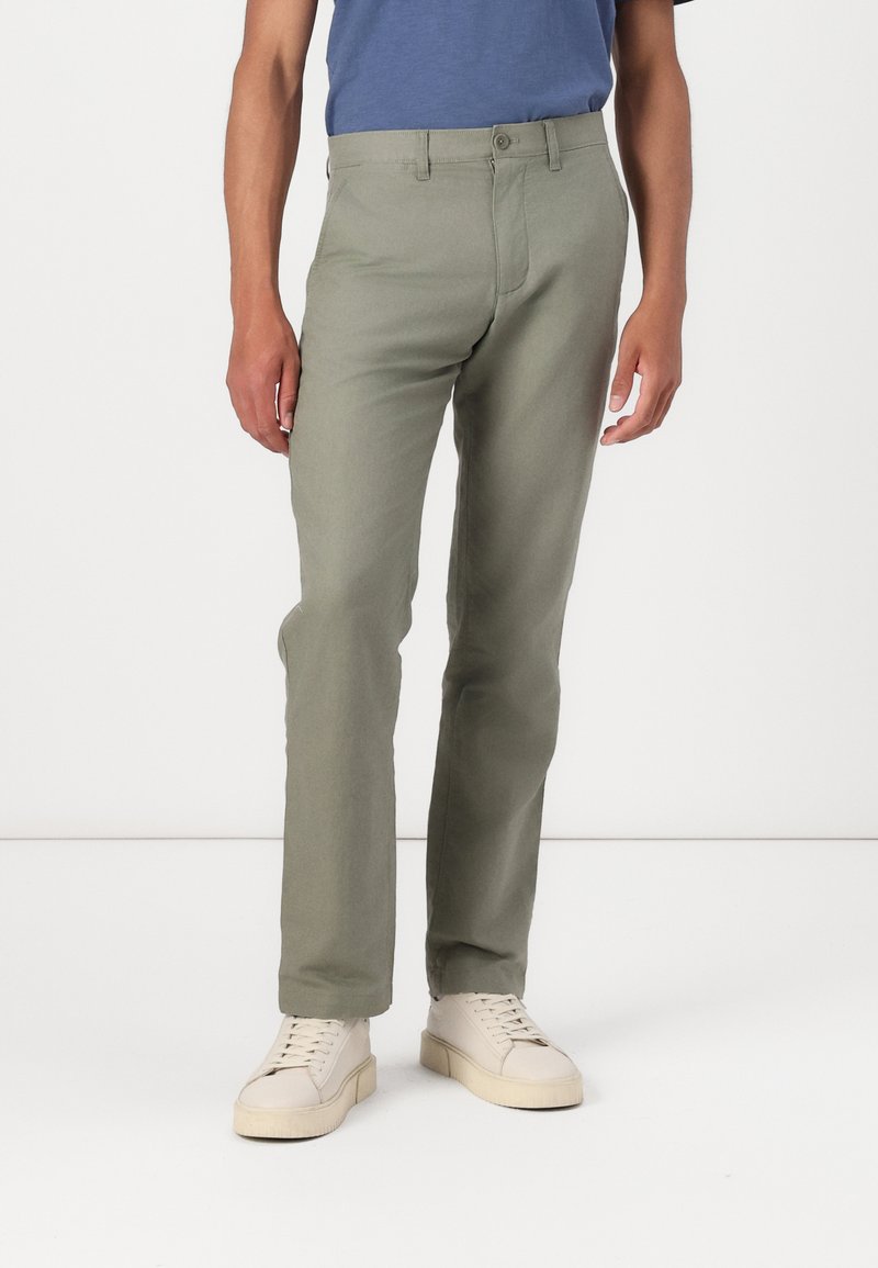 Light green trousers made of soft fabric, featuring a classic design with five pockets, a button closure, and straight legs.