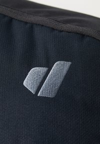 Black fabric with a textured surface, featuring a grey embroidered logo that includes two stylized shapes. Edge has a smooth finish.