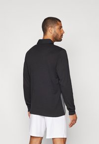 Umbro Polo - black/multi coloured