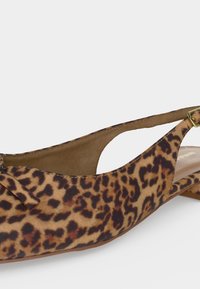 Πλακέ γόβα slingback με λεοπάρ σχέδιο, μυτερή μύτη, μικρή λεπτομέρεια με φιόγκο και ρυθμιζόμενο λουράκι με χρυσή αγκράφα.