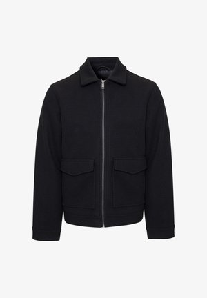 Zwarte jas met ritssluiting, gemaakt van een wolmix. Heeft een spreidkraag, twee voorzakken en geribbelde boorden. Soepele textuur en een op maat gemaakte pasvorm.