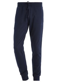 Pantalones deportivos azul marino de tela suave, con una cintura elástica con cordón, bolsillos laterales y puños ajustados.