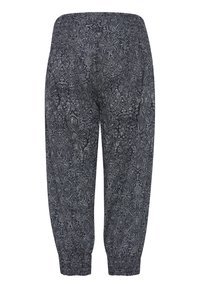 Mönstrade byxor i mörk marinblå med ljusa blommönster, elastisk midja, samlade anklar och en avslappnad passform.