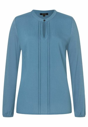 Langarm-Bluse aus weichem, hellblauem Stoff. Mit Rundhalsausschnitt, der ein Schlüsselloch-Detail und Falten entlang der Vorderseite aufweist. Gummierte Manschetten.