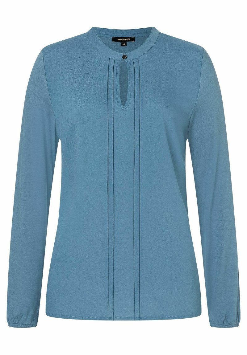 Langarm-Bluse aus weichem, hellblauem Stoff. Mit Rundhalsausschnitt, der ein Schlüsselloch-Detail und Falten entlang der Vorderseite aufweist. Gummierte Manschetten.