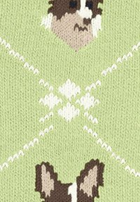 Dziergana tkanina w jasnym zielonym kolorze, z powtarzającymi się twarzami psów w brązowym i białym, z białymi wzorami w romby i zygzaki w całej strukturze.