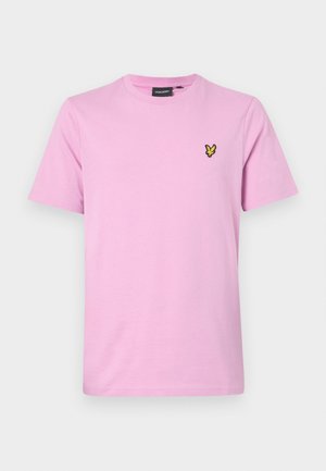 Svijetlo ružičasta pamučna majica s okruglim izrezom, kratkim rukavima i malim žutim i crnim izvezenim logom ptice na prsima.