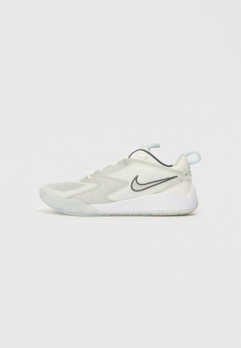 Lichtgrijze sportschoen met een gestructureerde bovenkant, voorzien van een zwarte Nike swoosh, een gevoerde rand, en een doorschijnende zool met sprankels.