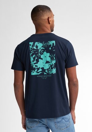 Navy t-shirt featuring a turquoise floral graphic on the back, soft cotton material, crew neck, and short sleeves.
