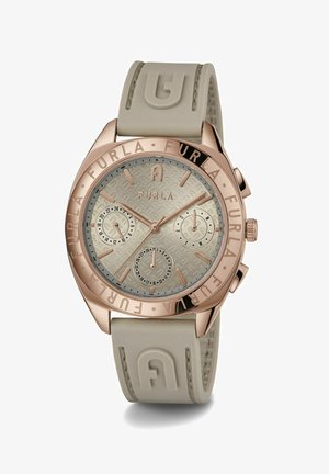Złoty różowy zegarek chronograficzny z teksturowanym beżowym cyferblatem, gumowym paskiem i wytłoczonym napisem ‚FURLA’ na bezel.