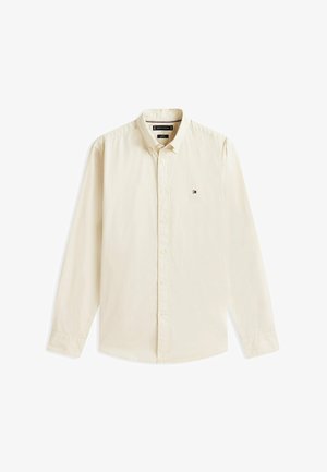 Beiges langärmliges Hemd mit Knöpfen, Kragen und kleinem Tommy Hilfiger-Logo auf der linken Brust.