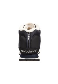 Black and navy athletic shoe featuring a plush inner lining, textured mesh upper, and branded heel with white logo accents.