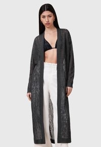 Lång, öppen framsidan cardigan i mörkgrått stickat tyg med en genomskinlig textur och geometriskt mönster. Har långa ärmar och en avslappnad passform.