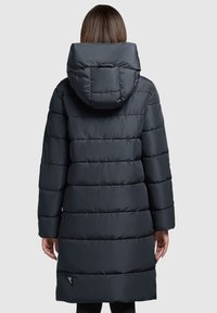 Dark gray puffer coat with horizontal stitching, a hood, and a longer silhouette. Lightweight material and side pockets are visible.