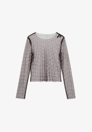 Gennemsigtig, langærmet top i lys lilla med et prikket mønster af små, runde pyntdetaljer. Afsluttet med mørk lilla kant langs kanterne.