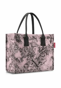 Rosa Tragetasche mit schwarzem Baum-Muster, strukturiertem Material, rechteckiger Form und zwei schwarzen Griffen. Mit rotem Markenlogo an der Seite.