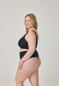 Czarny dwuczęściowy strój kąpielowy z topem z dekoltem typu scoop i majtkami z wysokim stanem. Gładka, elastyczna tkanina z minimalną ilością szwów i bez nadruków.