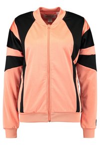 Růžová sportovní bunda s černými panelovými akcenty, zipem vpředu, žebrovanými manžetami a spodním lemem, vyrobená z hladké látky. Má zaoblený límec.