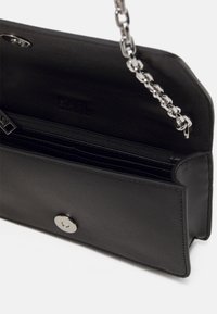 Black leather handbag with a textured finish, silver chain strap, and a snap closure. Interior features card slots and a zip pocket.