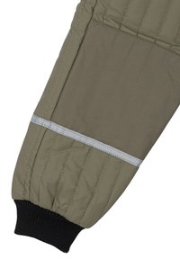 Olive green puffer jacket sleeve with quilted texture, elastic black cuff, and reflective gray accent stripe at the seam.