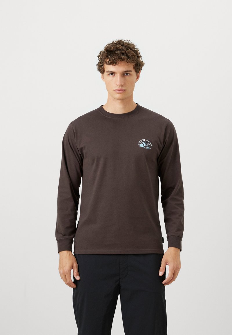 Long-sleeve, dark brown cotton T-shirt with a round neck and a small blue mountain graphic on the left chest. Smooth texture.