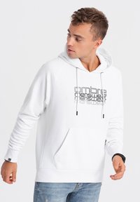 Witte hoodie met een voorzak, voorzien van zwart gedrukte tekst. Gladde katoenmixstof en ribgebreide manchetten. Casual pasvorm.