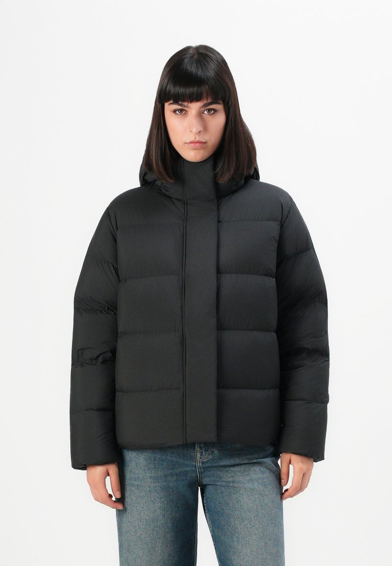 Black puffer jacket with a high collar and hood, featuring a quilted design with horizontal seams. Material appears smooth and slightly shiny.