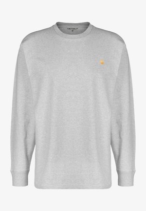 Világosszürke, hosszú ujjú pulóver, puha pamut keverékből készült. Kerek nyakú, és egy kis narancssárga logó található a bal mellen.