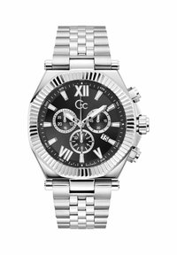 Srebrn nož iz nerjavečega jekla z črnim številčnico, rimskimi številkami, tremi pomožnimi številčnicami in prikazom datuma. Ima teksturirano obrobo in kovinsko zapestnico.