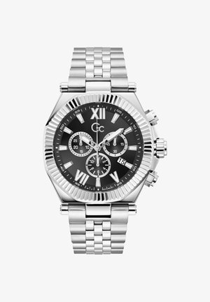 Sudraba nerūsējošā tērauda pulkstenis ar melnu ciparnīcu, romiešu ciparu indeksiem, trim subciparnīcām un datuma rādītāju. Tam ir teksturēts rāmītis un metāla aproce.