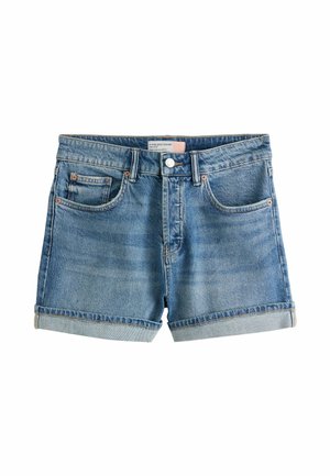 Sinised teksapüksid, millel on ülesrullitud ääred, ees nupud ja lukk, vööaasad ning kaks eesmist taskut, sealhulgas münditasku.