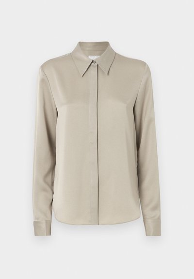 Beige long-sleeve shirt with a classic collar, smooth texture, front button closure, and subtle sheen. Tailored fit with rounded hemline.