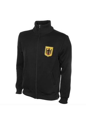 Black zip-up jacket with stand-up collar, featuring a yellow shield patch with a black eagle emblem on the left chest.
