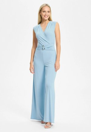 Combinaison bleu clair avec un design cache-cœur, sans manches, et un accent circulaire argenté à la taille. Tissu lisse et fluide avec des jambes larges.