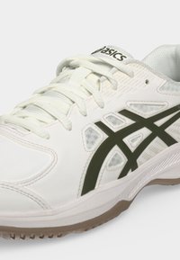 Λευκό αθλητικό παπούτσι Asics με μαύρες ρίγες λογότυπου, λευκά κορδόνια και ανοιχτό καφέ σόλα, εμφανίζεται από τα πλάγια και από μπροστά.