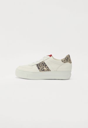White leather sneakers with a leopard print accent on the side, red heel, flat sole, and traditional lace closure.