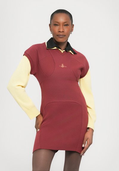 Ribbed dress in burgundy with a black collar and yellow long sleeves. Features a fitted design and subtle logo detail on the chest.