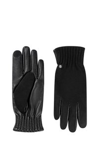 Schwarze Lederhandschuhe mit glatter Oberfläche, gerippten Bündchen und einem kleinen silbernen Emblem. Touchscreen-kompatible Fingerspitzen an einem Handschuh.