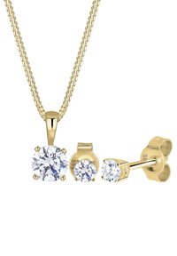 Guldtonet smykkesæt med en pendantsmykke, der har en stor rund cubic zirconia, og matchende stud øreringe med mindre sten.