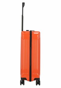 Hard-shell orange suitcase with vertical ridges, black zipper, and a retractable handle. Features four wheels for easy maneuvering.