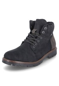 Bottine noire en daim avec col en tissu gris, bout rond et épaisse semelle en caoutchouc noir. Comprend des œillets en métal et des lacets gris.