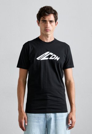 Black cotton t-shirt with short sleeves and a crew neck. Features a prominent white graphic logo on the front. Standard fit, smooth texture.