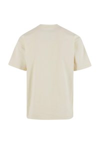 Beige bomull t-skjorte med klassisk rund hals og korte ermer, med en jevn tekstur og standard passform, sett fra baksiden.