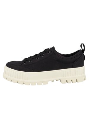 Low-top black sneaker with thick white ridged sole and black laces, featuring a fabric pull tab on the heel.