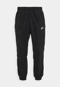 Svarta fleece-joggingbyxor med elastisk midja, elastiska muddarna och en vit Nike-logotyp på den övre vänstra låret.