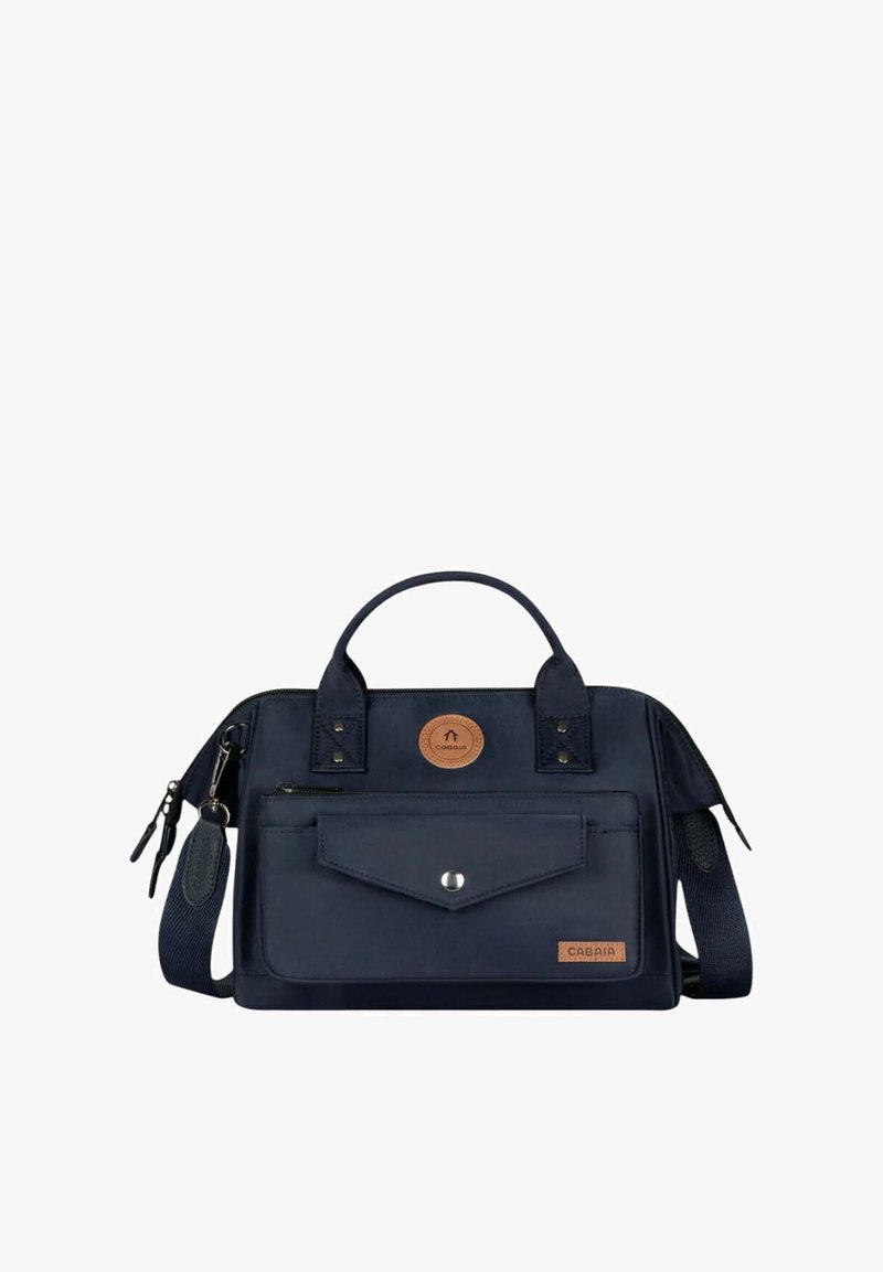 Navy blue fabric bag with dual top handles, detachable shoulder strap, front pocket with snap closure, and circular leather logo patch.