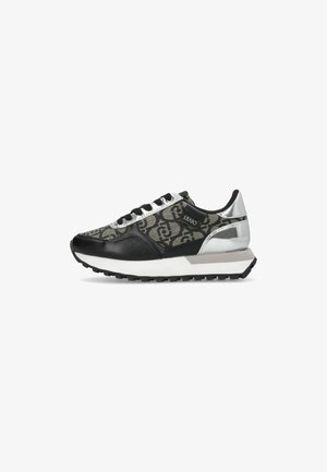 Black and gray athletic sneaker featuring a patterned upper, silver accents, reflective details, and a textured sole.