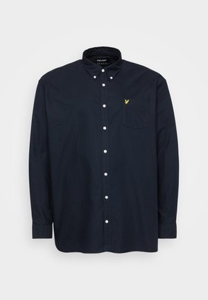 Navy blue button-up shirt made of cotton with a chest pocket. Features white buttons and a small yellow logo on the pocket.