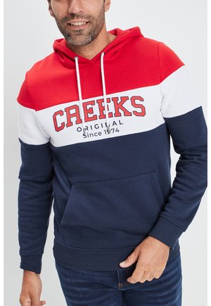 Felpa con cappuccio caratterizzata da blocchi di colore rosso, bianco e blu navale. Logo "CREEKS" sul petto, concorde e tasca frontale. Tessuto in misto cotone.